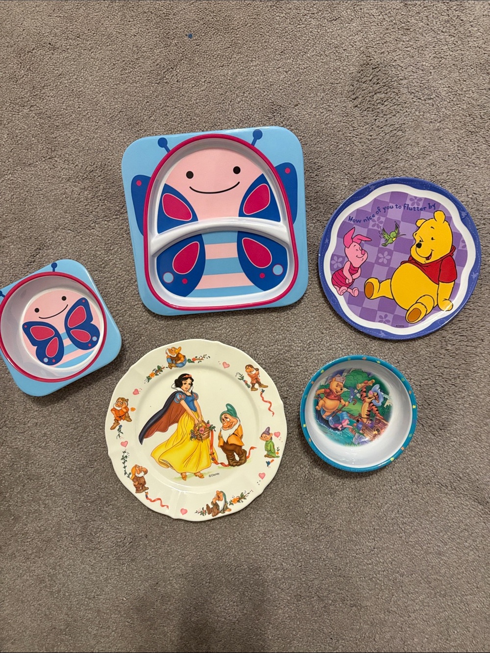 An assortment of toddler and small children’s unbreakable plates and bowls.